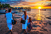 Sunset and local people on the beach in th Isla La Pirraya island, Usulutánin Jiquilisco Bay in Gulf of Fonseca Pacific Ocean El Salvador Central America.