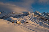France, Haute Savoie, massif of Aravis, Le Grand Bornand, after a snowfall on the ski area in the Duche valley sunset on the hamlet of the col des Annes