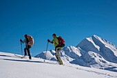 France, Haute Savoie, the Aravis massif, Manigod, hiking at Mont Sulens, 2 hikers on the ridge and Mount Charvin