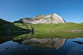 France, Haute Savoie, Aravis Massif, Manigod, hiking Lake Charvin, the lake and the north face of Mount Charvin