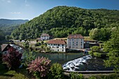 France, Doubs, Loue valley, one of many thresholds over the river reflect the village of Lods one of the most beautiful villages in France