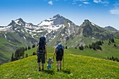 France, Haute Savoie, massif of Aravis, Manigod hike to the tip of Orsiere, small family at the top and Mount Charvin