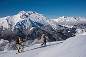 France, Haute Savoie, the Aravis massif, Manigod, hiking at Mont Sulens, 2 hikers on the ridge and Mount Tournette