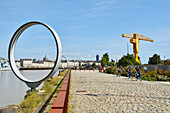 France, Loire Atlantique, Nantes, Ile de Nantes, quai des Antilles, Buren's rings on Loire River quays and the cupola of Notre Dame du Bon Port and the yelow Titan crane