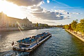 France, Paris, the banks of the Seine listed as World Heritage by UNESCO, a fly boat in front of the Musee d'Orsay