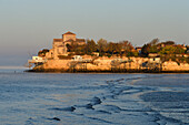 France, Charente Maritime, Saintonge, Gironde Estuary, Saintonge,Talmont sur Gironde, labelled Les Plus Beaux Villages de France (The Most Beautiful Villages of France), huts on stilts for Carrelet (fisherman's hut) fishing net and Sainte Radegonde church in Saintonge Romanesque style of the 12 th century