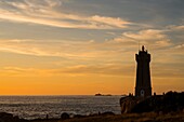 France, Cotes d'Armor, Ploumanach, Perros-Guirec, Pink granite coast, the lighthouse of Ploumanac'h or lighthouse of Mean Ruz at sunset on the footpath of Customs or GR Grande 34 hiking trail