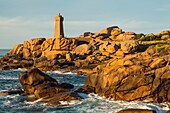 France, Cotes d'Armor, Ploumanach, Perros-Guirec, Pink granite coast, the lighthouse of Ploumanac'h or lighthouse of Mean Ruz at sunset on the footpath of Customs or GR Grande 34 hiking trail