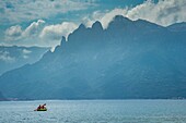 France, Corse du Sud, Porto, Gulf of Porto listed as World Heritage by UNESCO, Gradelle beach, canoe in the gulf and Capu d'Orto mountain