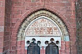 France, Correze, Dordogne Valley, Collonges la Rouge, labelled Les Plus Beaux Villages de France (The Most Beautiful Villages of France), village built in red sandstone, entrance door of St Pierre Church overcomed by a cathedral tympanum in limestone