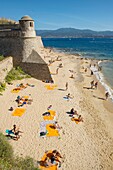 France, Corse du Sud, Ajaccio, a tower of the citadel Miollis and the beach,the orange towels are those of the cruise liner