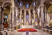 France, Puy de Dome, Auvergne Volcanoes Regional Nature Park, Monts Dore mountain range, Orcival, 12th century Notre Dame d'Orcival basilica, choir, granite high altar, statue of the Virgin in Majesty, carved capitals and stained glass windows