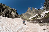 France, Haute Corse, Corte, Restonica Valley, in the regional natural park, hiking to the lakes of altitude, passage of neve on the path between Lake Melo and Capitello and tip of 7 lakes