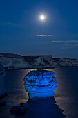 France, Corse du Sud, Bonifacio, a rock called sand grain forms a curious island a few meters from the shore under the lighting of the full moon