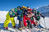 Frankreich, Haute Savoie, Massiv des Mont Blanc, die Contamines Montjoie, die Kinder im Kurs des Skis mit Lehrer ESF, der ein Foto der Gruppe mit Tontelefonen nimmt