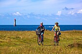 France, Finistere, Ponant Islands, Armorica Regional Nature Park, Iroise Sea, Ouessant Island, Biosphere Reserve (UNESCO), Cyclists towards the Jument Lighthouse in Spring