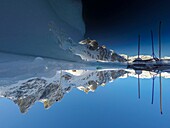 France, Isère (38), Belledonne, Chamrousse, Robert lakes bordered and dominated on the east by Petit Van (2,439 meters), Grand Van (2,448 meters) and Grand Sorbier (2,526 meters), reflecting the mountain peaks through a hole dug in the ice to allow diving