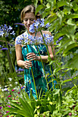 Woman looking at Agapanthus flowers