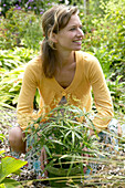 Woman with pot of ornamental grasses