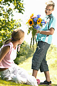 Teenager with bouquet of summer flowers