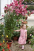 Girl beside tree lilies