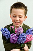 Boy holding hyacinths