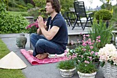 Man meditating in garden