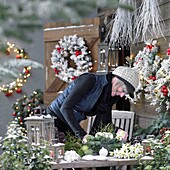 Woman making christmas arrangement