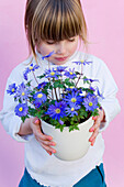 Girl holding Anemone blanda Blue Shades
