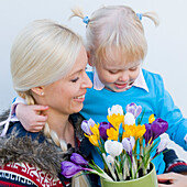Mother and daughter holding crocus