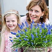 Mother and daughter holding Muscari