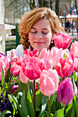 Woman smelling tulips