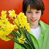 Boy holding daffodils