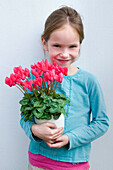 Girl holding Cyclamen