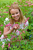 Woman touching Dicentra spectabilis