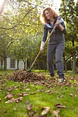 Woman raking leaves