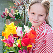 Girl holding spring flowers