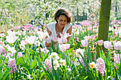 Woman in field of spring flowers