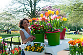 Woman looking at spring containers