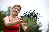 Woman carrying Ophiopogon planiscapus Niger