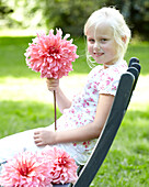 Girl holding dahlia