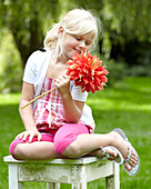 Girl holding dahlia