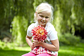 Girl holding dahlia