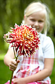 Girl holding dahlia