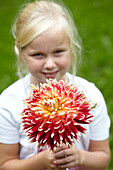 Girl holding dahlia