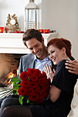 Couple holding red roses