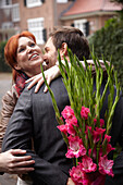 Man holding bunch of flowers