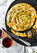 Sweet baklava strudel with pistachios