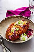 Sweet potato with pulled chicken, coleslaw and sour cream
