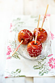 Glazed candy apples with sesame seeds